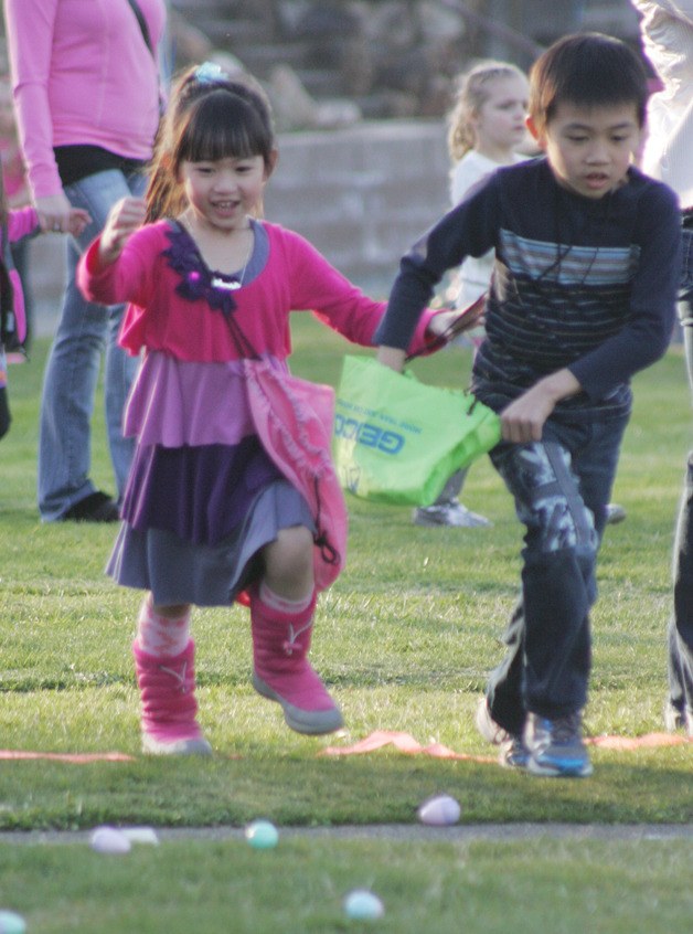 Jaasmine and Alex Nguyen race for the eggs at the Black Diamond Gun Club Easter Egg Hunt Friday