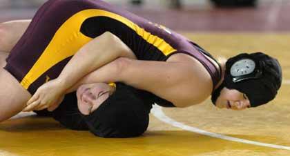 Mikaela Kilcup puts the squeeze on an opponent during state wrestling action Friday.