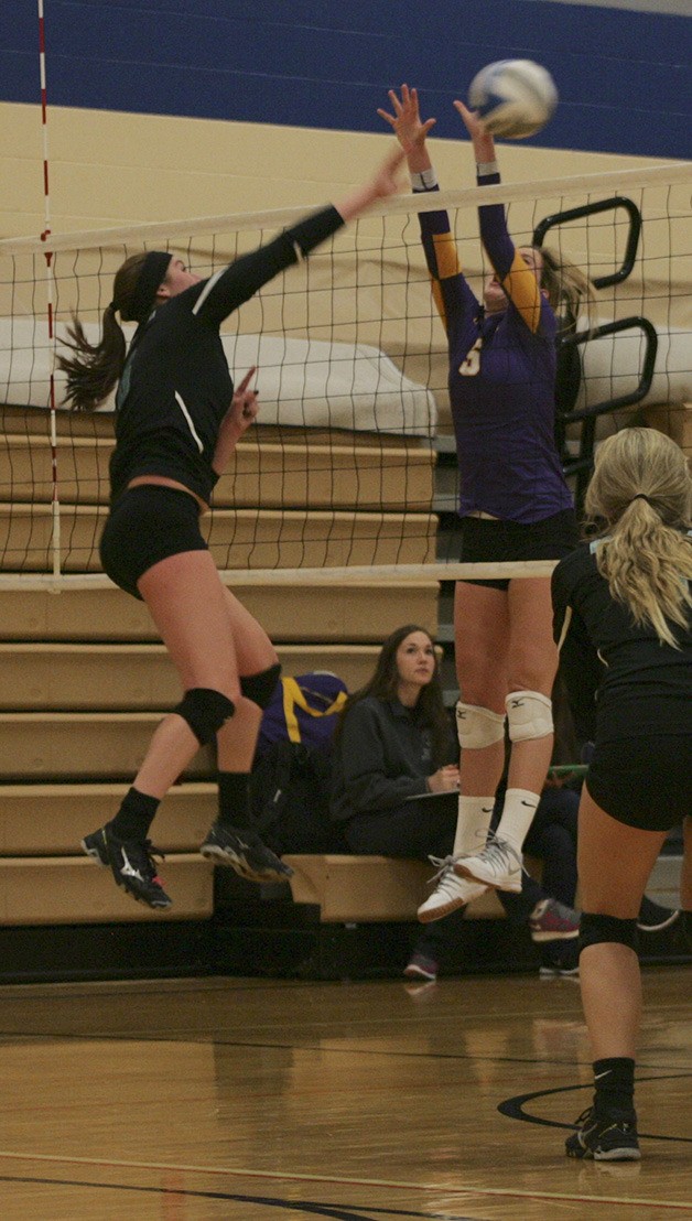 Bonney Lake freshman Carly Gibbon hits the ball through the Columbia River defenders hands Friday in the Panthers first match of the tournament.