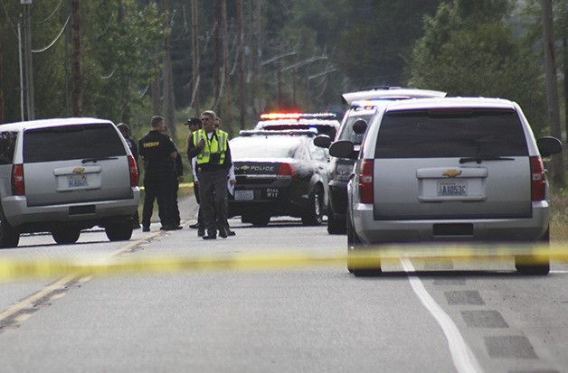 King County Sheriff's deputies and police officers at the scene of the stolen car pursuit and crash on 400th Street Southeast past 196th Avenue Southeast June 4.