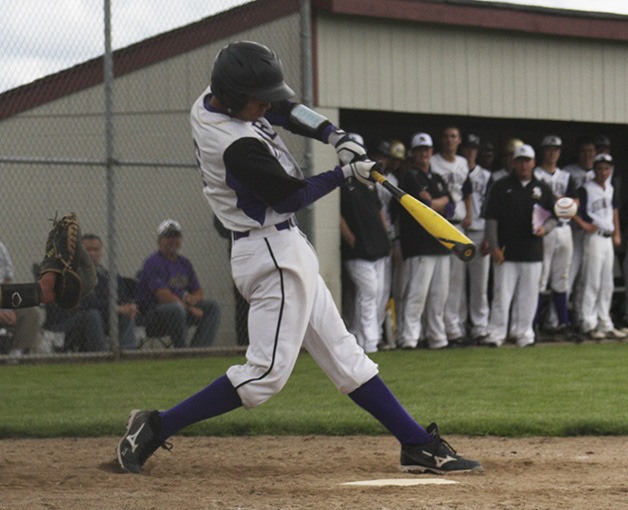 Catcher Bryan Adkins hits the ball during the first round game against Lynden Saturday. The Spartans won 3-0.