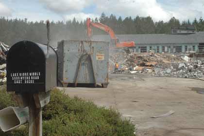 The new school looms behind the pile that used to be the old building as workers continue the demolition of Lakeridge Middle School June 30.