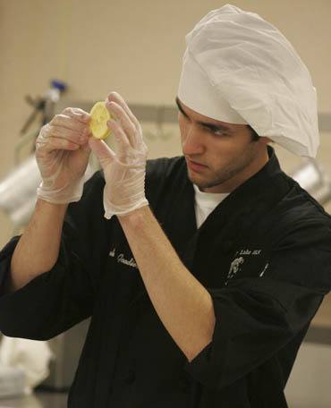 A Bonney Lake student examines a lemon slice in the kitchen of the Death By Chocolate fundraiser Saturday.