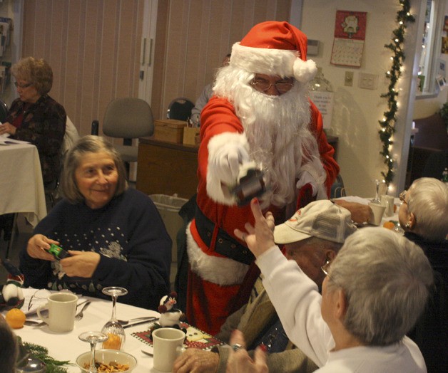 Santa hands out presents at the Bonney Lake Senior Center Christmas lunch.
