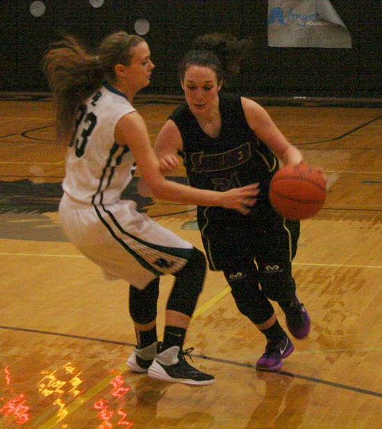 A Spartan rushes past Panther senior Brooklyn Gratzer during the varsity game Jan. 12.