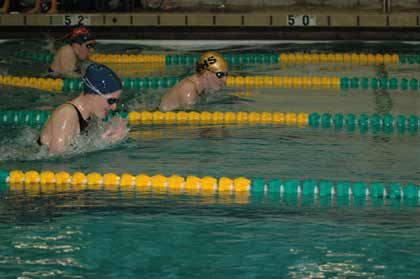 Enumclaw High sisters Katie and Allie Larrea race neck-in-neck at the start of the 100-yard breaststroke at the SPSL 3A meet Friday.