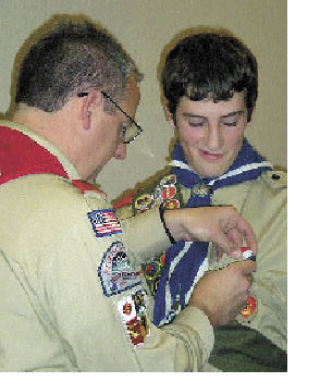 Scout leader Kory Custer pins the Eagle  medal to Blake Halvorsen’s uniform pocket during an Eagle Court of Honor  ceremony  Jan. 11.