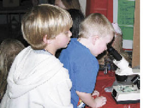 Black Diamond  Elementary School  students Kendrick Herbst and Michael Bennett take turns looking through a microscope
