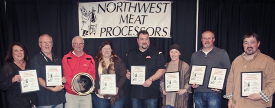 The crew from Olson’s Meats and Smokehouse displays the hardware won during the most recent convention of the Northwest Meat Processors Association.