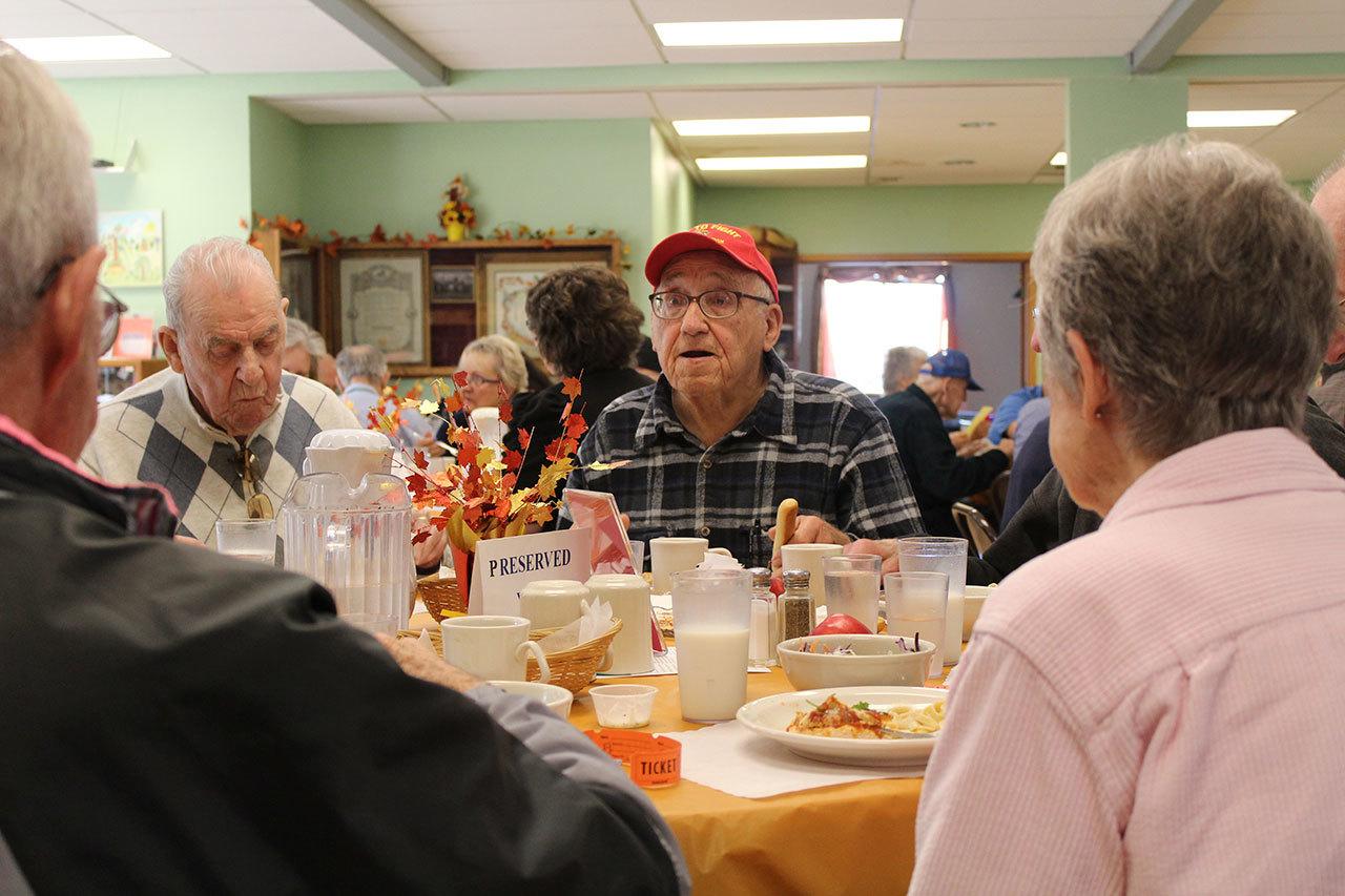 Seniors enjoy a hot meal at the Black Diamond Community Center every Tuesday and Thursday at noon. Photo by Ray Still.