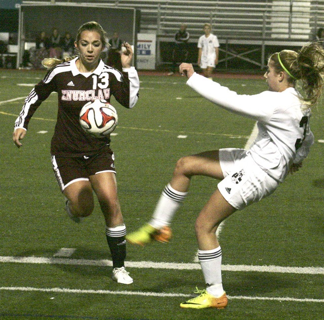 Enumclaw's Kaylee Markonich battles a Bonney Lake Panther for a loose ball during a Thursday playoff game at Sunset Chev Stadium in Sumner. Enumclaw won and advanced in district play