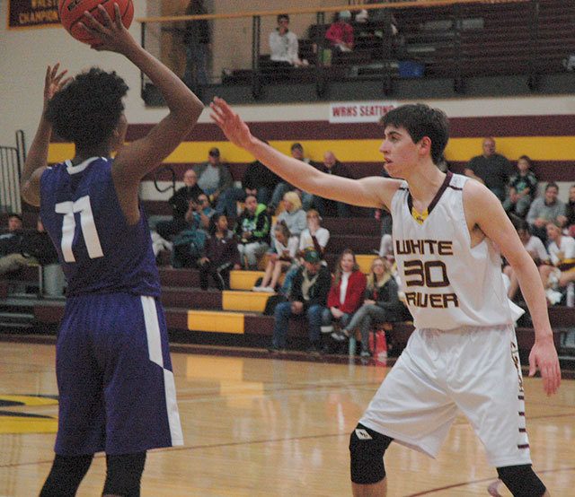 White River senoir Alex Wallen pressures Foster’s Jamari Severson during the Hornets’ Friday night rout of the Bulldogs. Wallen posted a game-high 20 points. Photo by Kevin Hanson.