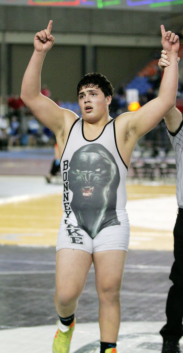 Bonney Lake junior Sam Peterson raises his arms after winning the 220-pound state title Saturday at the Mat Classic in the Tacoma Dome. Peterson’s win secured the team championship for the Panthers in the 3A division. Photo by Dennis Box.