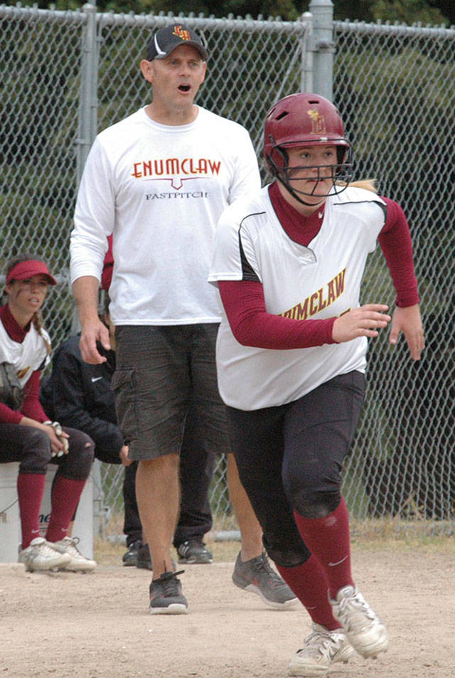 Enumclaw High’s fastpitch coach Mike Eckhart encourages base runner Becca Fabris as she takes off third heading for home to score during a 2016 playoff game. Photo by Kevin Hanson.
