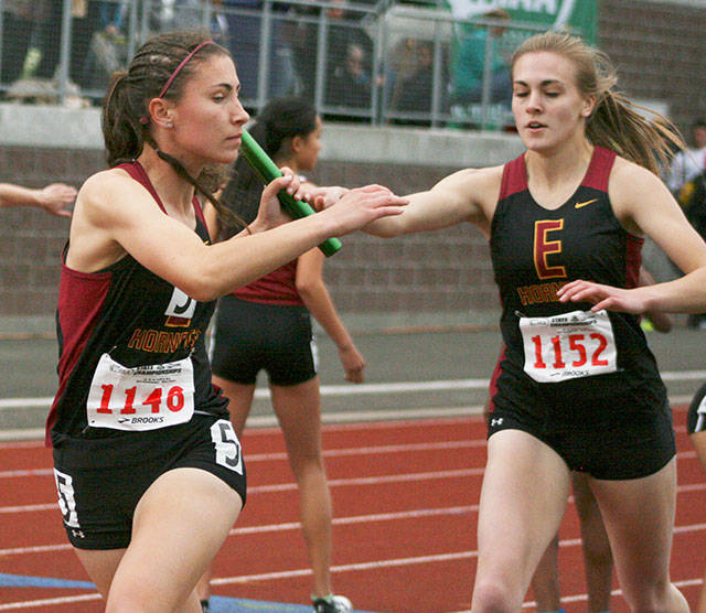 Last year, Hornets Aleea Gwerder took the baton from Josie Neu in the last leg of the 1,600 relay. Enumclaw took the gold at the state event. Both Hornets are now graduated. Photo by Dennis Box