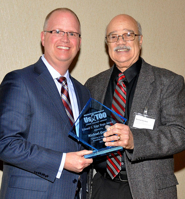 Michael Gordon, right, receiving his award with C. Todd Aherns, treasurer of UsTOO International. Submitted photo.