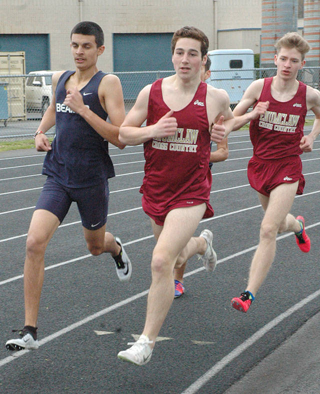 Enumclaw High’s Alec Ritter, middle, and Sam Lingwall compete during Thursday’s 1,600-meter race at Enumclaw High. The Hornet pair finished second and third, respectively, adding points to the EHS total. Photo by Kevin Hanson.