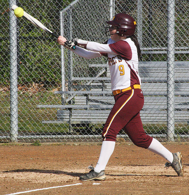 White River senior Alli Brewer has helped the Hornets race to familiar turf, atop the South Puget Sound League 3A standings. Also, she connects for a hit during a recent home game. Photo by Kevin Hanson.