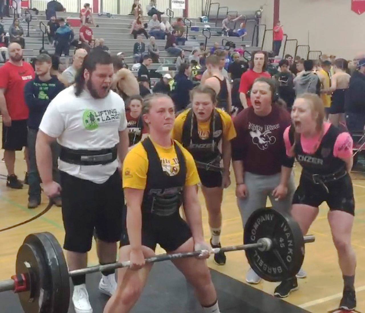 Marissa Bartels competes in the dead list for White River, successful with 305 pounds. Cheerins her on, from left, are teammate Parker Knaus, sister Marina Bartels, assistant coach Dani Barbee and Cheyenne Martin of North Beach High. Photo by Darren Bartels
