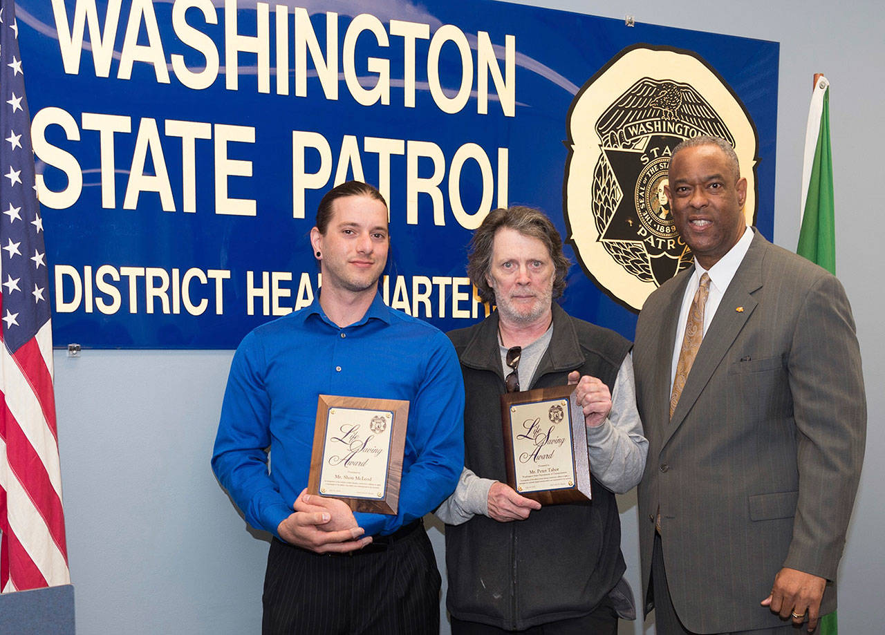 Honored for their lifesaving efforts were Shon McLead, left, and Peter Tabor. They received awards last week from Washington State Patrol Chief John Batiste. Photo courtesy of WSP