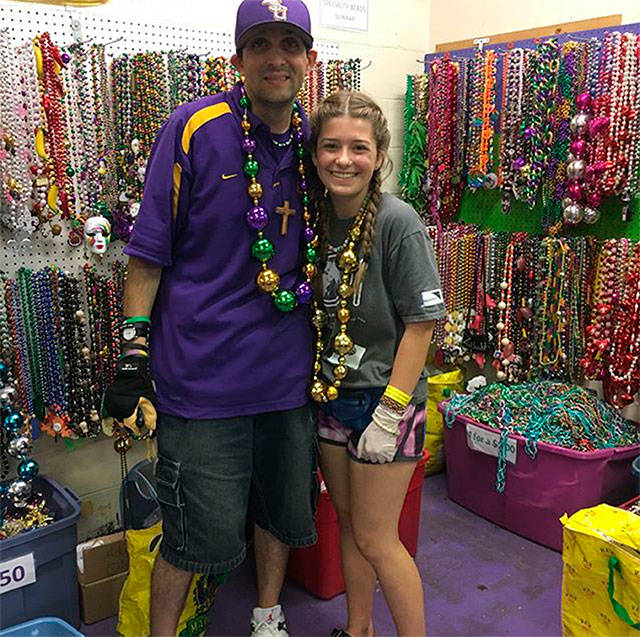 Enumclaw’s Maya Rismiller spent hours sorting Mardi Gras beads, a task that helps fund Arc, a New Orleans non-profit. Contributed photo