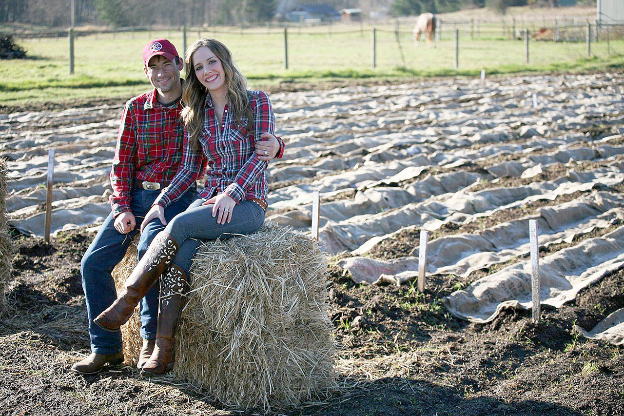 Ross and Venise Cunningham in front of their first garlic crop in 2013, when the first Goats and Garlic festival was held. Photo courtesy Laura Morceau