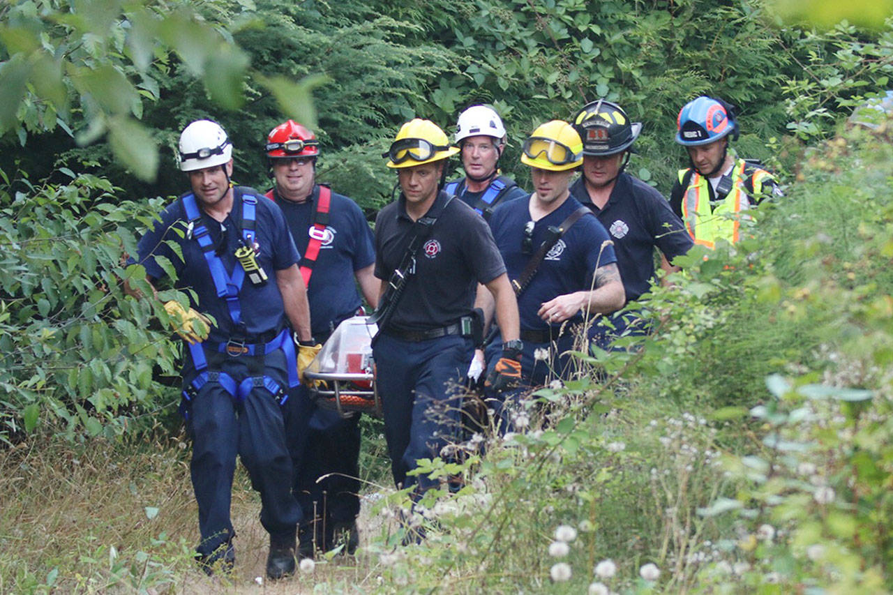 Despite minor injuries, patents from the Aug. 1 rescue were brought out on a stretcher. Photo courtesy of Puget Sound Regional Fire Authority