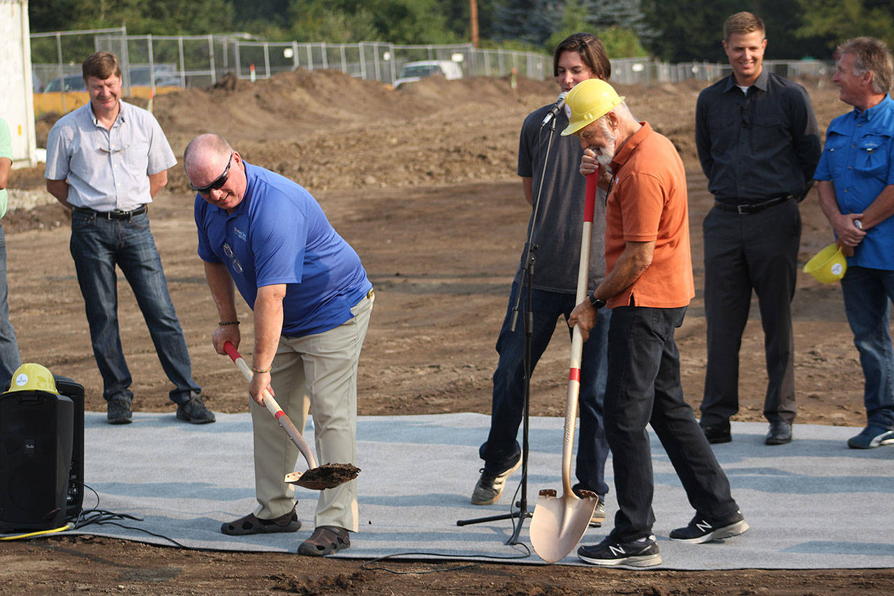 Mayor Neil Johnson and Teeter founder Rodger Teeter break first ground for Teeter’s new headquarters in Bonney Lake. Photo by Ray Still