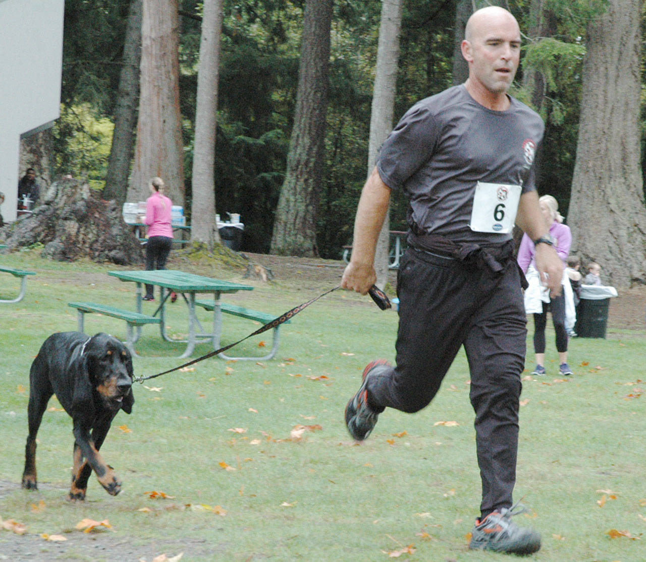 Enumclaw resident Steve Bannerot and his hound complete last year’s fun run, a benefit for Left Behind K9 Rescue, at Lake Wilderness. File photo by Kevin Hanson