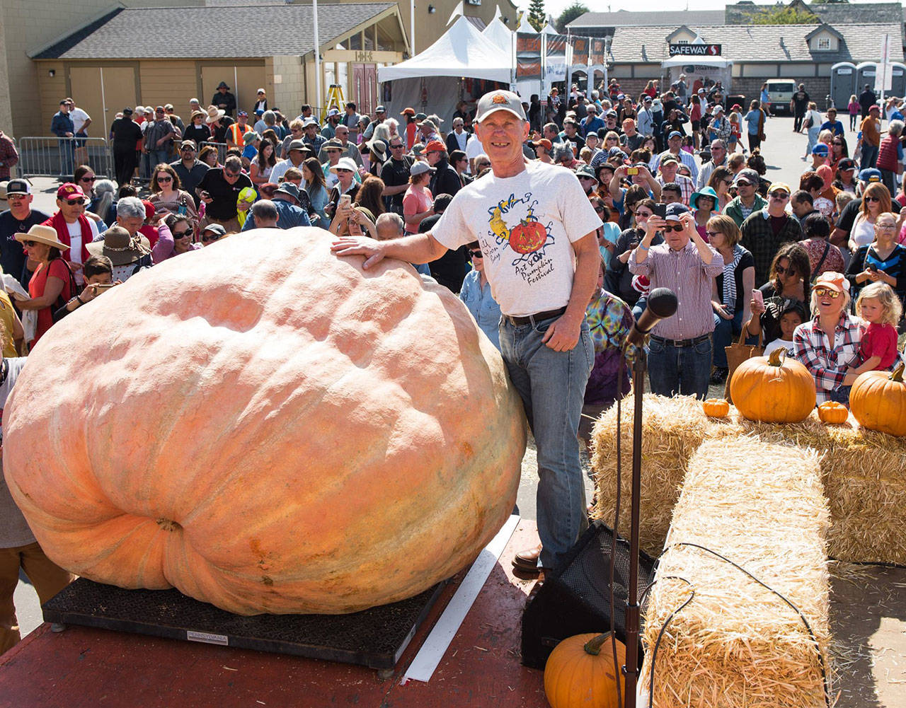 Joel Holland with his 2,323 pound Atlantic Giant pumpkin. Photo by Half Moon Bay Festival
