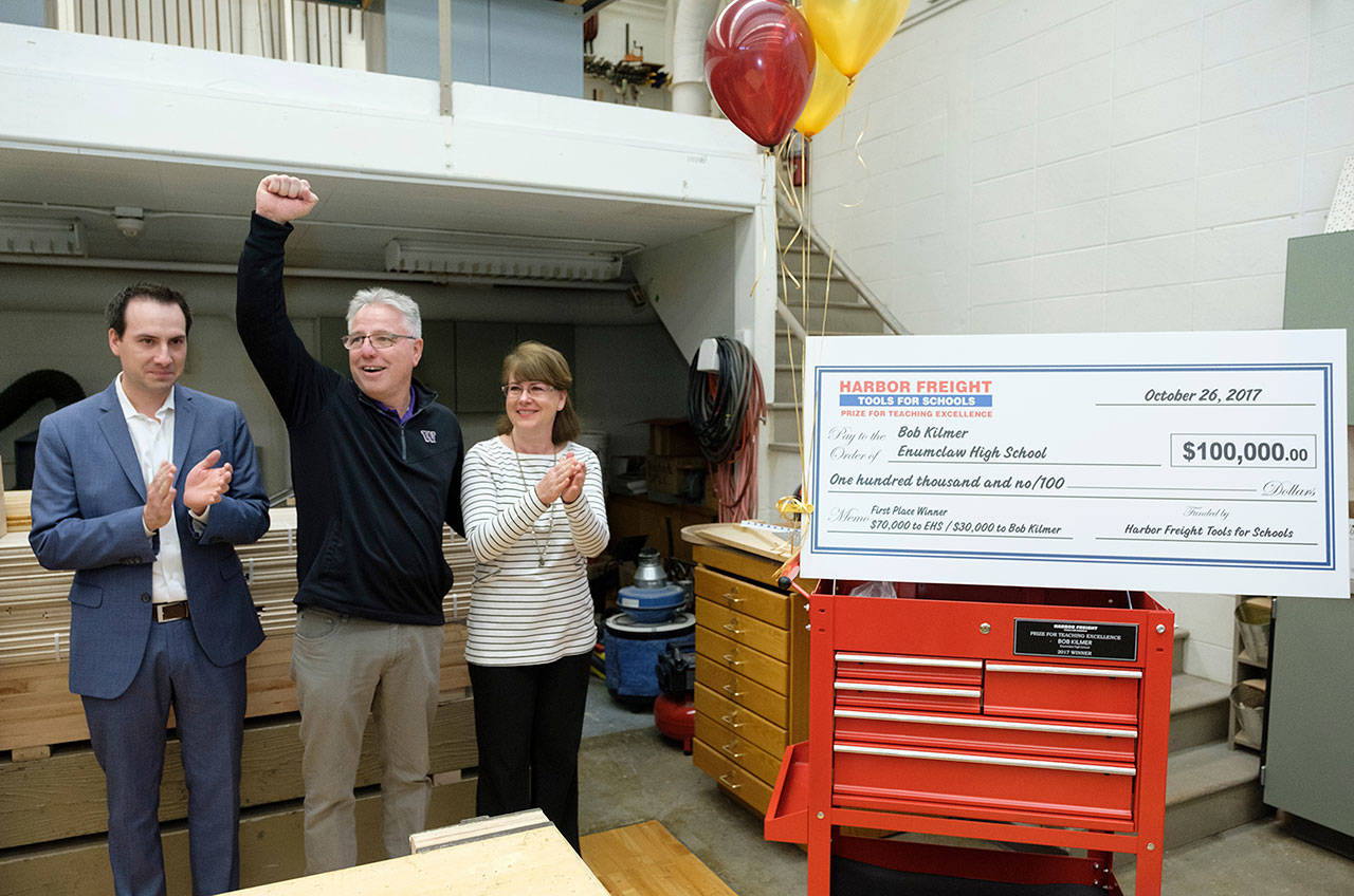 Enumclaw High School construction and architecture teacher Bob Kilmer, center, reacts after he was surprised with the news he and his school won the $100,000 Harbor Freight Tools for Schools Prize for Teaching Excellence, at Enumclaw High School on Thursday Oct. 26, 2017. Photo by Stephen Brashear
