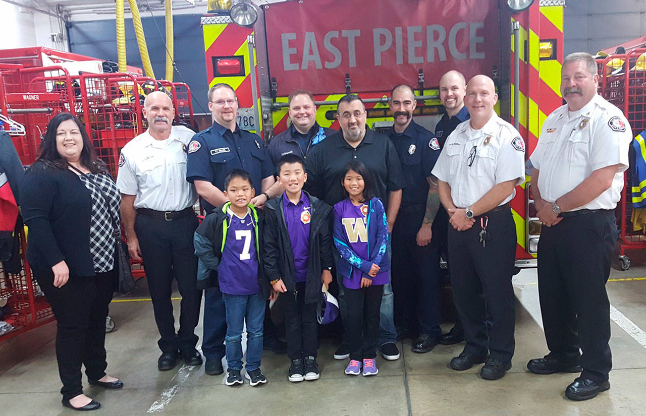 Jack Tatarian (center) are his wife Johanna and children Samuel, Isaia and Satapat with part of the EPFR crew (left to right) that responded to his medical emergency: Rick Goetz, Doug Mullins, Jason Brooks, Tim Jewitt, Mike Malland. Also pictured are Jeff Moore and Chief Bud Backer.