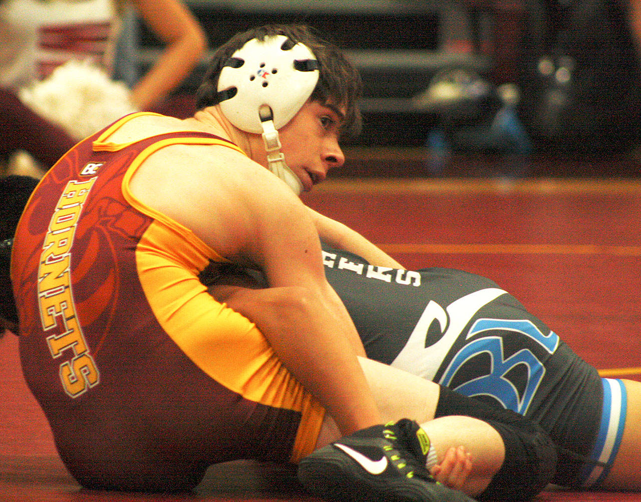 White Rivers Nate Belcourt battles his Bonney Lake opponent during a meet last week in the Hornet gym. Photo by Kevin Hanson