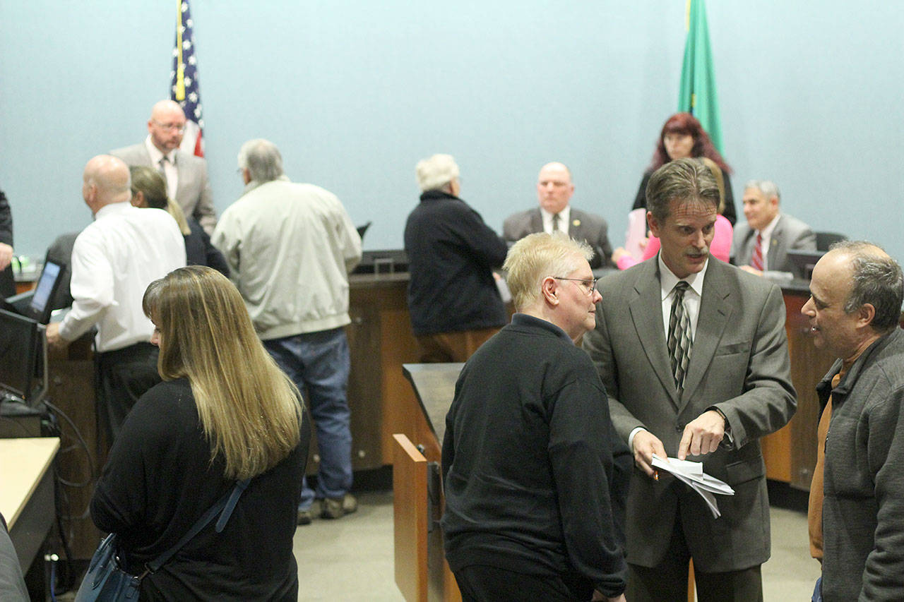 Many Bonney Lake residents attended the Jan. 9 council meeting to complain about high water bills, and engaged many City Council members, Mayor Neil Johnson and other staff members in conversation about the city’s findings after the meeting was over. Photo by Ray Still
