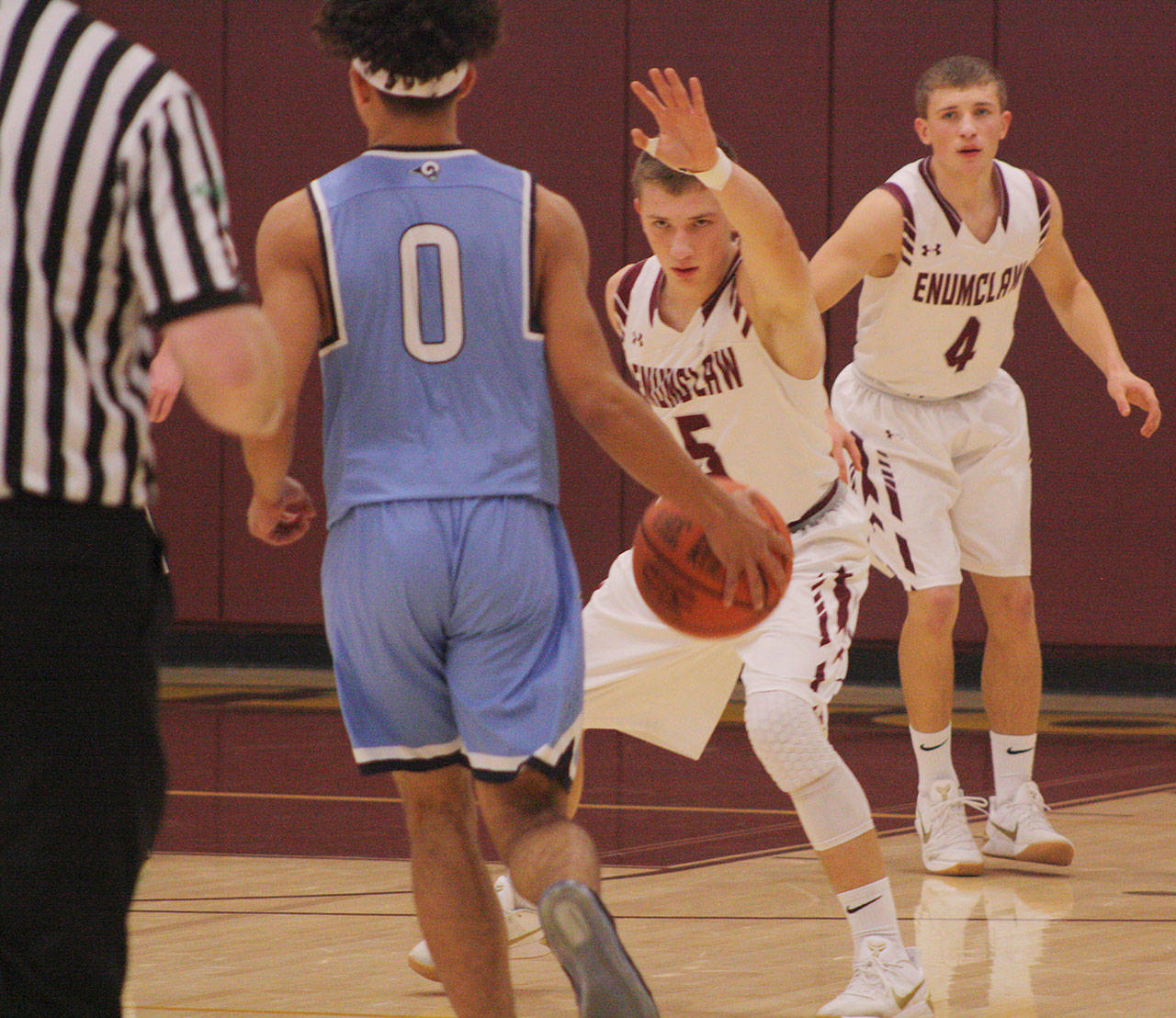 Enumclaw senior Bryson Engebretsen applies defensive pressure during the Hornets come-from-behind victory over the Rogers Rams. Photo by Kevin Hanson