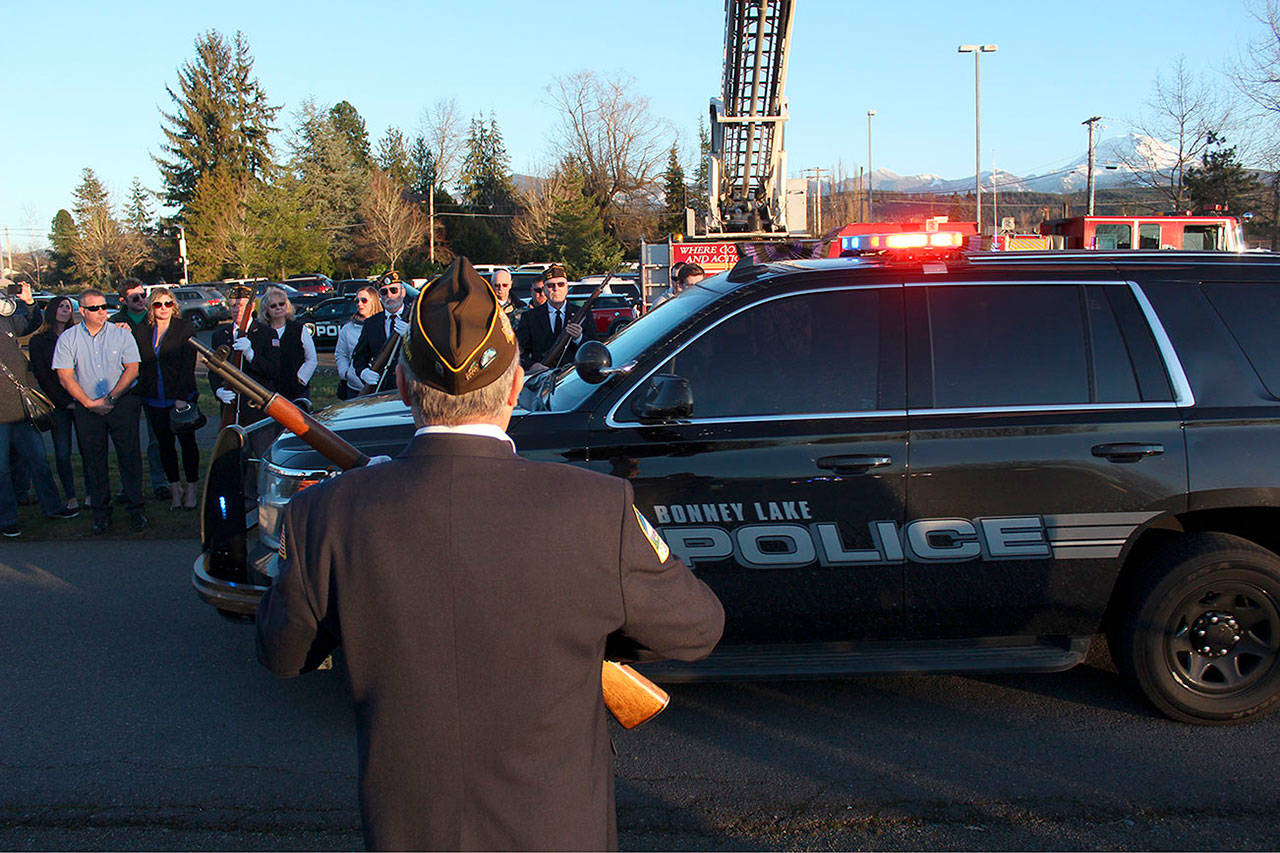 Family, friends, vets, and first responders lined the Weeks Funeral Home driveway to give honors to James Larson and Zach Roundtree as they passed in a police procession. Photo by Ray Still