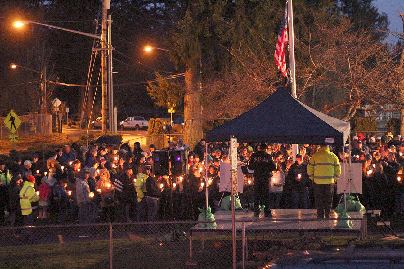 Despite the threat of rain and wind, hundreds turned out at Allan Yorke Park and lit candles in memory of the deceased. Photo by Ray Still