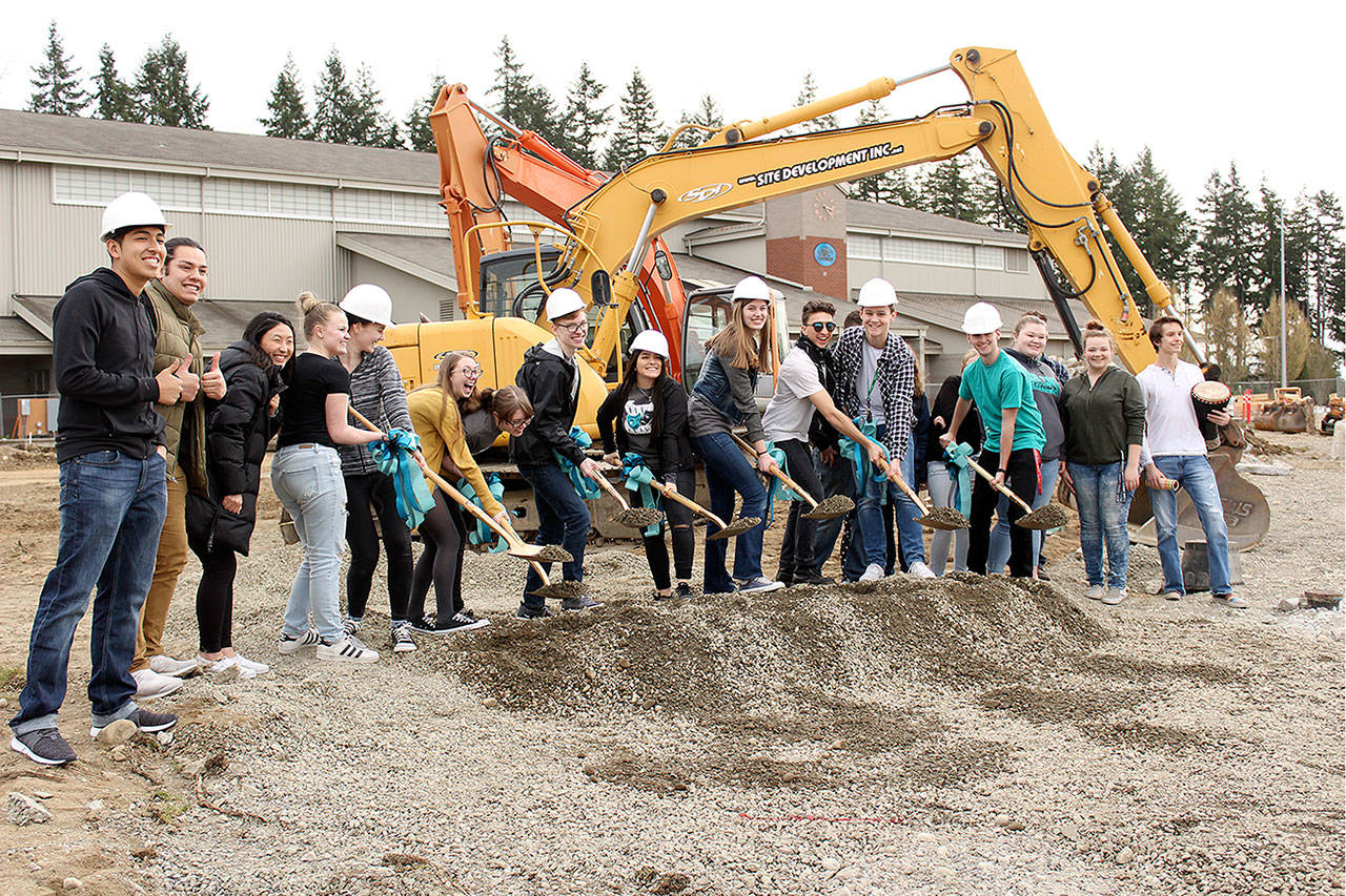 The BLHS Chamber Choir, who performed at the start of the groundbreaking, joined Jadin Bassett, Bryce Gaskill and other students to officially break ground for the Bonney Lake Performing Arts Center. Photo by Ray Still