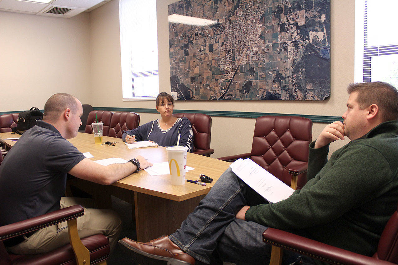 Enumclaw’s Park Director Michelle Larson meets with Councilmembers Kyle Jacobson, left, and Anthony Wright, right, about the future Enumclaw dog park. Photo by Ray Still