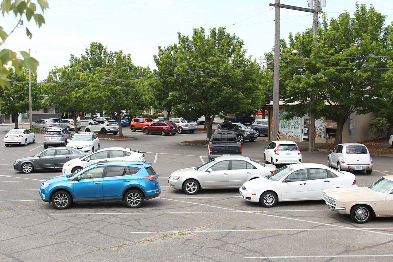 The parking lot behind the Arts Alive and Enumclaw Chamber of Commerce may be no more in the future, as the city is looking for a developer to build in the lot. Photo by Ray Still