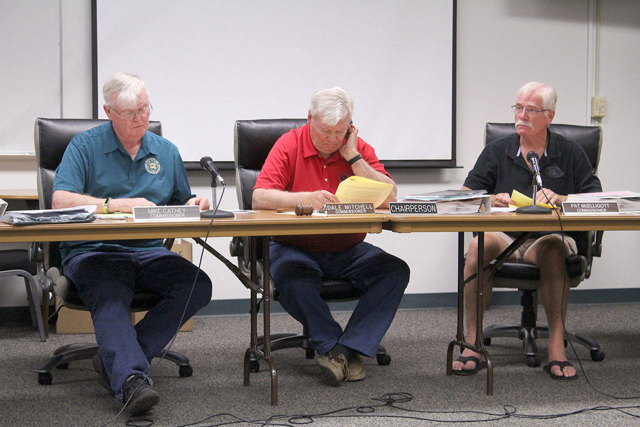 East Pierce Fire and Rescue commissioners read through the proposed bond ballot measure and the fire departments proposed Capital Facilities Plan before approving both unanimously on July 17. Photo by Ray Miller-Still