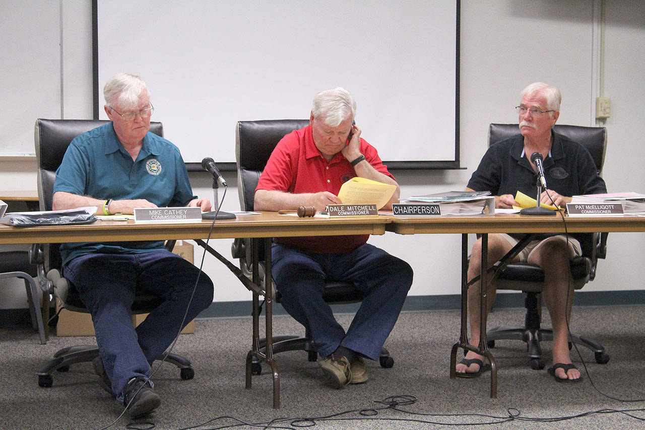 East Pierce Fire and Rescue commissioners read through the proposed bond ballot measure and the fire department’s proposed Capital Facilities Plan before approving both unanimously on July 17. Photo by Ray Miller-Still