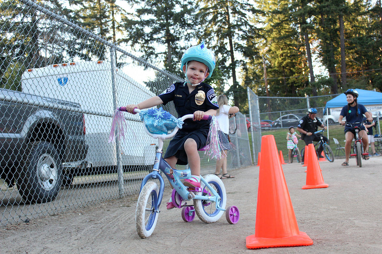 Rory Thayse came out in her Chief For A Day uniform to welcome all comers to Bonney Lake’s annual National Night Out last week, Aug. 7. Photo by Ray Still