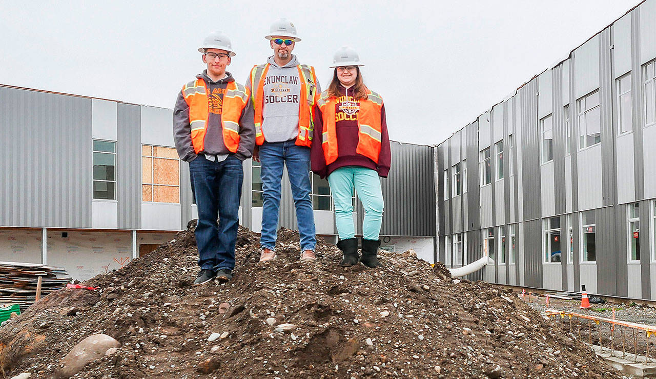 Rob Gunderson, flanked by kids Fulton and Piper, in the midst of construction on the Enumclaw High School campus. PHOTO BY DAVID W. COHEN/FORMA