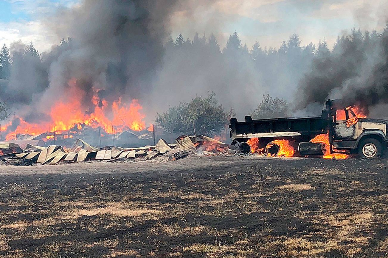 Brush fire burns 12 acres, several buildings and vehicles