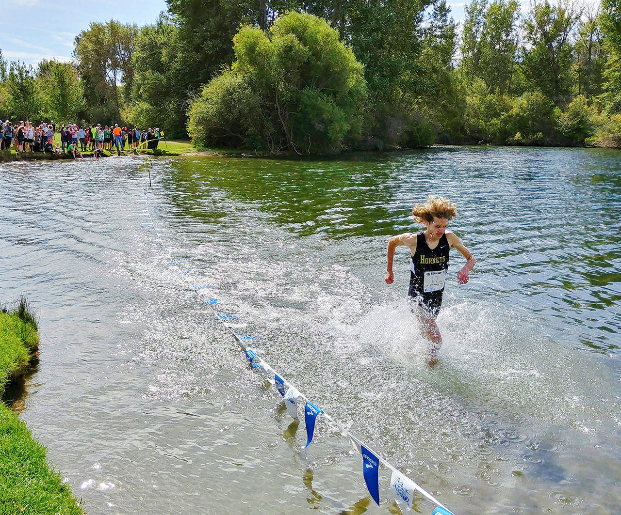 Sam Lingwall leads the Enumclaw pack through the water Saturday at Irene Rhineheart Riverfront Park. The water was an element of the Ellensburg Relays. Photo by Tod Witzel