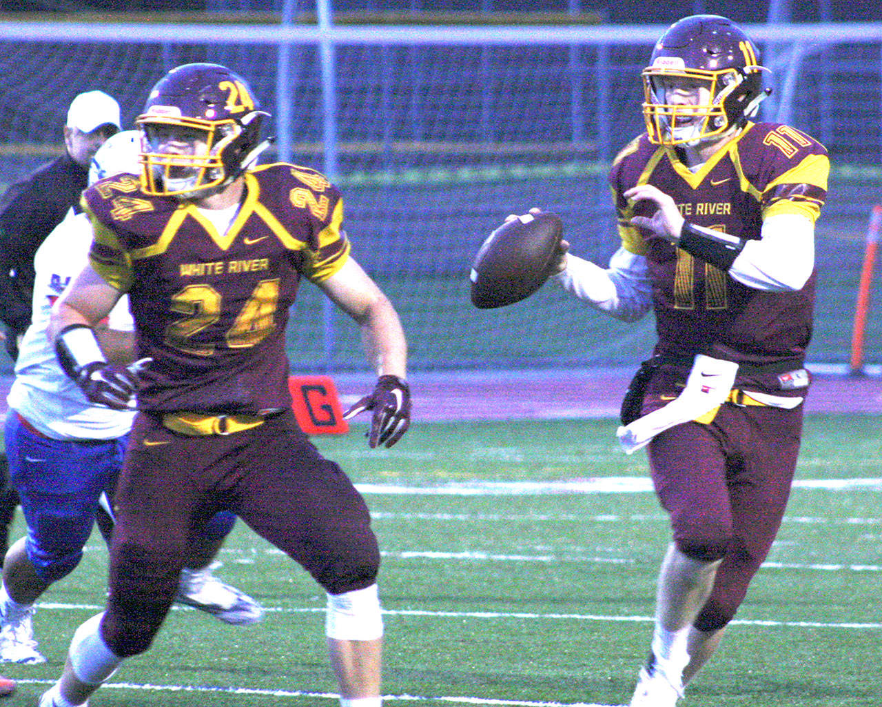 White River quarterback TJ Strochein looks for a receiver during Friday’s victory while Jack Ervien looks to provide some protection. KEVIN HANSON PHOTO
