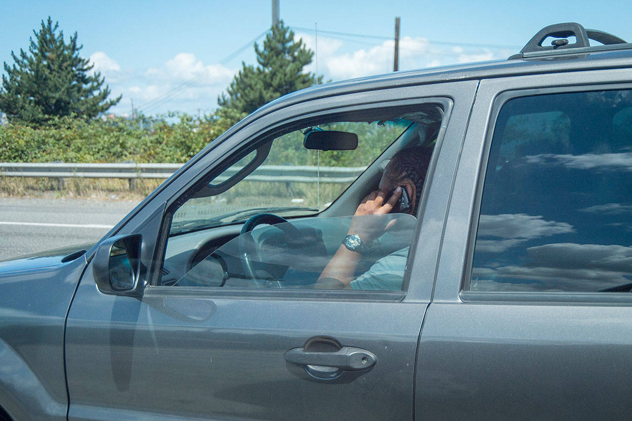 If you aren’t using hands-free applications or devices, using your phone while parked and out of the way of traffic, or calling 911, using your phone while driving is a ticket-able offense. Image courtesy WSP