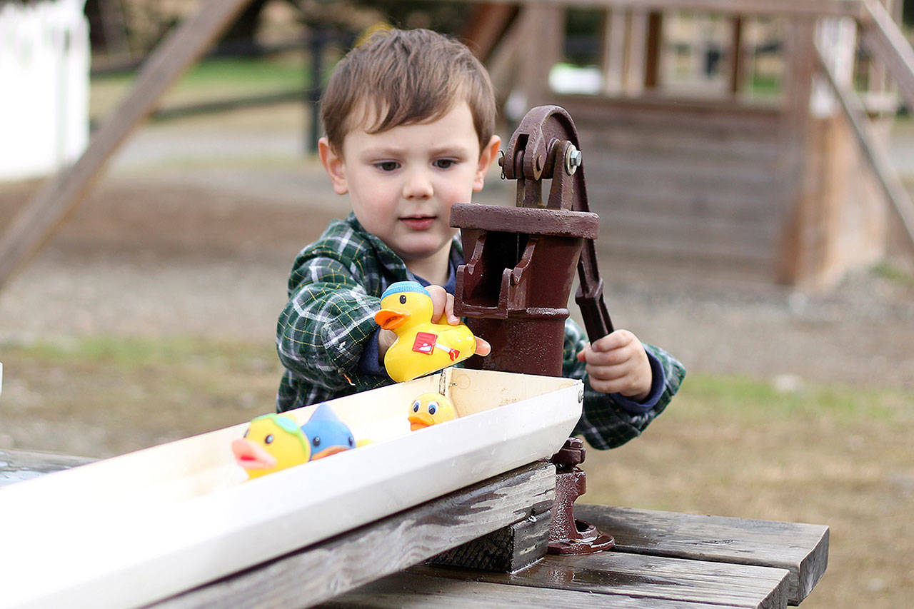 Elijah Cunningham races rubber ducks at Thomasson Family farms. File photo Ray Miller-Still