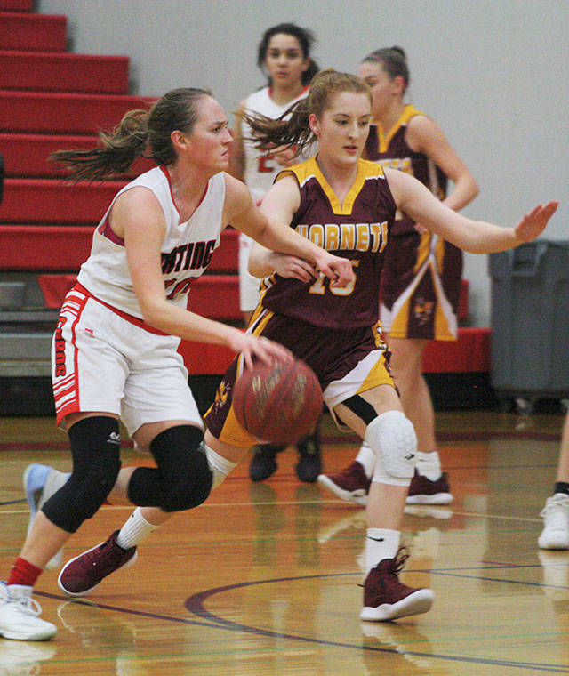 Hornet sophomore Kara Marecle applies defensive pressure against her Orting opponent on Dec. 14. Photo by Kevin Hanson